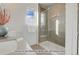 Clean bathroom with a walk-in shower, modern vanity and large window at 2732 W 68Th Ave, Denver, CO 80221