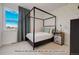 Secondary bedroom with a four-poster bed and patterned wallpaper at 2732 W 68Th Ave, Denver, CO 80221