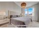 Spacious bedroom with plush bedding, large windows, and mountain views at 2732 W 68Th Ave, Denver, CO 80221