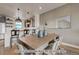 Kitchen and dining area with farmhouse table and dark cabinetry at 2732 W 68Th Ave, Denver, CO 80221