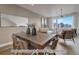 Modern dining area with a large wooden table and woven chairs at 2732 W 68Th Ave, Denver, CO 80221