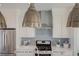 Close up of kitchen, showcasing a unique backsplash and pendant lighting at 2732 W 68Th Ave, Denver, CO 80221