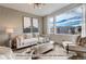 Bright and airy living room with large windows and comfortable seating at 2732 W 68Th Ave, Denver, CO 80221