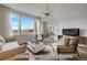 Spacious living room with large windows, comfortable seating, and a view of the city at 2732 W 68Th Ave, Denver, CO 80221