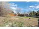 Expansive backyard with mature trees, play equipment, and patio offering a private outdoor retreat at 6779 W 79Th Cir, Arvada, CO 80003