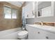 Bathroom featuring tile floors and shower with a tiled accent mirror at 6779 W 79Th Cir, Arvada, CO 80003