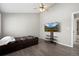 Bedroom with hardwood floors, featuring a ceiling fan, TV, and closet at 6779 W 79Th Cir, Arvada, CO 80003