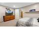 Relaxing bedroom with modern TV, neutral tones, comfortable bed, and ample storage space at 6779 W 79Th Cir, Arvada, CO 80003