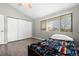 Bedroom with hardwood floors, closet, ceiling fan and large window at 6779 W 79Th Cir, Arvada, CO 80003