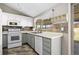 Well-lit kitchen featuring gray and white cabinets, modern appliances, and a bright window at 6779 W 79Th Cir, Arvada, CO 80003