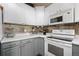 Close-up of a well-equipped kitchen with modern appliances and stylish two-tone cabinetry at 6779 W 79Th Cir, Arvada, CO 80003