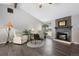 Bright living room featuring wood floors, fireplace and cozy seating, great for relaxation and comfort at 6779 W 79Th Cir, Arvada, CO 80003
