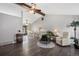 Spacious living room with wood floors, a ceiling fan, and an adjacent dining area, perfect for entertaining at 6779 W 79Th Cir, Arvada, CO 80003