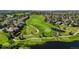 Aerial view of a golf course community surrounded by lush greenery and residential homes on a sunny day at 7713 S Zante Ct, Aurora, CO 80016