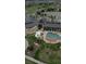 Aerial view of the clubhouse featuring a swimming pool, well-manicured landscape, and ample parking at 7713 S Zante Ct, Aurora, CO 80016