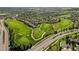 Panoramic aerial shot of a golf course community, featuring meticulously manicured greens and scenic landscaping at 7713 S Zante Ct, Aurora, CO 80016