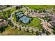 Aerial view of community tennis courts with manicured lawns, and a golf area at 7713 S Zante Ct, Aurora, CO 80016