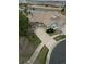 Scenic aerial view of a home with a pond in the background and view of a paved driveway and mature trees at 7713 S Zante Ct, Aurora, CO 80016