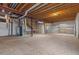 Unfinished basement area provides opportunity for customization, with exposed beams and mechanical systems at 7713 S Zante Ct, Aurora, CO 80016