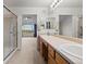 Bathroom with double sinks and glass-enclosed shower offering great views from the adjacent room at 7713 S Zante Ct, Aurora, CO 80016