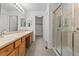Bathroom features a double sink vanity, glass shower and neutral color palette at 7713 S Zante Ct, Aurora, CO 80016