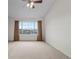 Spacious bedroom with large window providing natural light and scenic views at 7713 S Zante Ct, Aurora, CO 80016