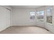 Bright bedroom with large windows and a closet, providing ample space and natural light at 7713 S Zante Ct, Aurora, CO 80016