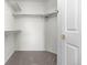 Walk-in closet providing ample storage space with multiple shelves and rods for hanging clothes at 7713 S Zante Ct, Aurora, CO 80016