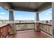 The private deck features stone pillars and overlooks a scenic view of the surrounding landscape at 7713 S Zante Ct, Aurora, CO 80016