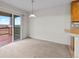 Open dining area features sliding glass doors to the outdoor deck with beautiful views at 7713 S Zante Ct, Aurora, CO 80016