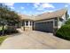 Attractive home with a gray exterior, stone accents, a well-maintained yard, and a large driveway at 7713 S Zante Ct, Aurora, CO 80016