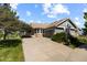 Charming single-story home with a well-manicured front lawn and a concrete driveway leading to an attached two-car garage at 7713 S Zante Ct, Aurora, CO 80016