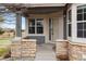 Inviting front porch with stone accents and neutral-toned exterior, creating a warm and welcoming entrance at 7713 S Zante Ct, Aurora, CO 80016