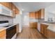 Bright kitchen featuring wooden cabinets, modern appliances, and light-colored countertops and flooring at 7713 S Zante Ct, Aurora, CO 80016