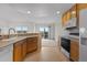 The kitchen seamlessly connects to the dining area and offers a scenic view from the sink at 7713 S Zante Ct, Aurora, CO 80016
