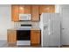 Kitchen area featuring modern appliances, lots of wooden cabinets, and light countertops at 7713 S Zante Ct, Aurora, CO 80016