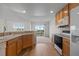 Kitchen area features lots of wooden cabinets, stone countertops and a pass through to the patio at 7713 S Zante Ct, Aurora, CO 80016
