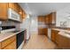 Well-equipped kitchen with ample cabinets, modern appliances, and tile flooring at 7713 S Zante Ct, Aurora, CO 80016