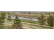 Picturesque scenery showcases a tranquil pond and lush greenery, providing a peaceful escape at 7713 S Zante Ct, Aurora, CO 80016