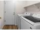 The laundry room features a washer and dryer with a shelf for storage, providing convenient laundry solutions at 7713 S Zante Ct, Aurora, CO 80016