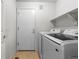Laundry room features a modern washer and dryer, with upper shelf at 7713 S Zante Ct, Aurora, CO 80016