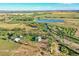 Stunning aerial view of a sprawling estate with a private lake and lush greenery at 10690 County Road One, Longmont, CO 80504