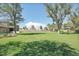Expansive backyard with lush green grass, mature trees, and ample space for outdoor activities at 10690 County Road One, Longmont, CO 80504