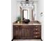 Bathroom vanity with dark wood cabinets, marble countertop, and vessel sink at 10690 County Road One, Longmont, CO 80504
