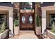Welcoming front entrance with double doors, decorative plants, and stylish lanterns at 10690 County Road One, Longmont, CO 80504