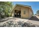 Exterior of a large garage with multiple doors and ample parking at 10690 County Road One, Longmont, CO 80504
