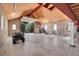 Inside a large garage featuring garage door, workbench, and high ceilings at 10690 County Road One, Longmont, CO 80504