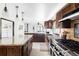 Spacious kitchen featuring custom wood cabinets, stainless steel appliances, and granite countertops at 10690 County Road One, Longmont, CO 80504