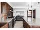 Spacious kitchen with stainless steel appliances, dark wood cabinets, granite countertops, and center island at 10690 County Road One, Longmont, CO 80504