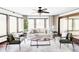 Bright living room with large windows, neutral decor, and comfortable seating at 10690 County Road One, Longmont, CO 80504